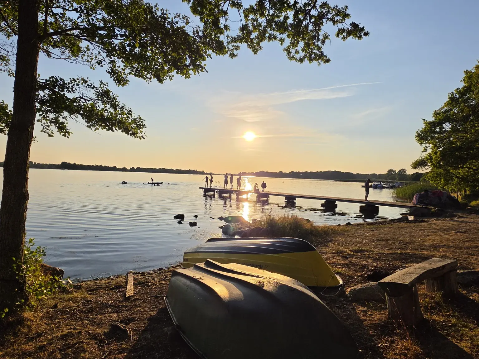 Familj vid bryggan under solnedgången
